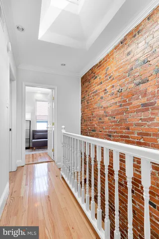 a view of hallway with wooden floor