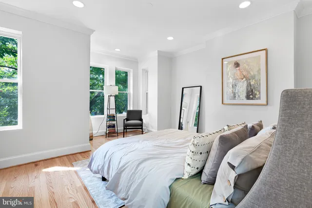 a bedroom with a bed and a large window