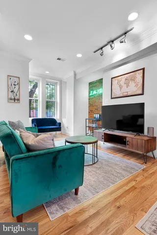 a living room with furniture window and a flat screen tv