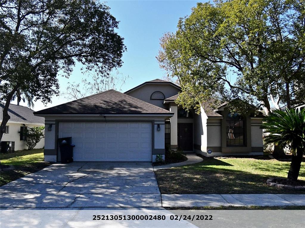 3877 Waterview Loop Winter Park, FL 32792 - Photo 1 of 1 a front view of a house with a yard and garage