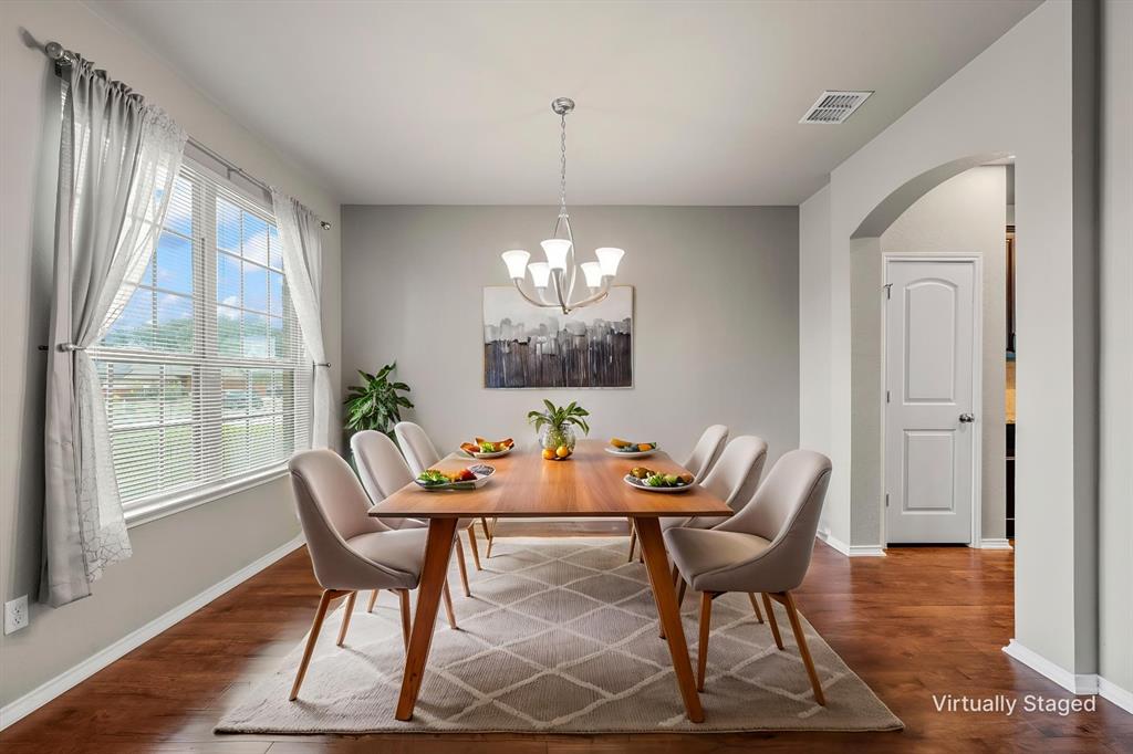 202 Milky Way Road Bruceville, TX 76630 - Photo 11 of 39 a dining room with furniture a chandelier and wooden floor