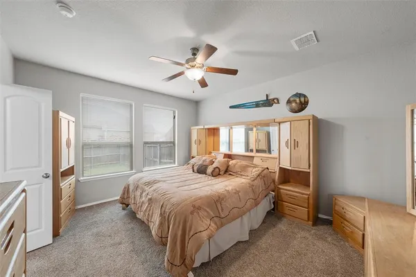 a bedroom with a bed and a large window