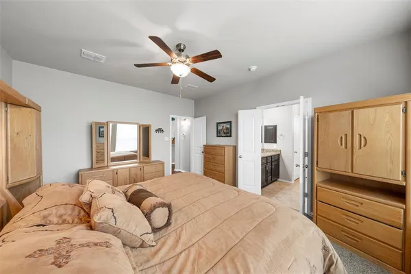 a bedroom with a large bed and closet