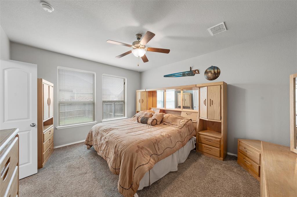 202 Milky Way Road Bruceville, TX 76630 - Photo 17 of 39 a bedroom with a bed and a large window