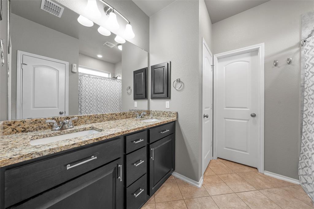 202 Milky Way Road Bruceville, TX 76630 - Photo 19 of 39 a bathroom with a granite countertop sink and a mirror