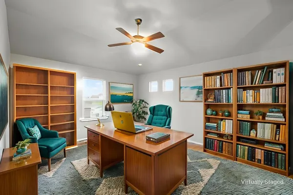 a living room with furniture and a book shelf
