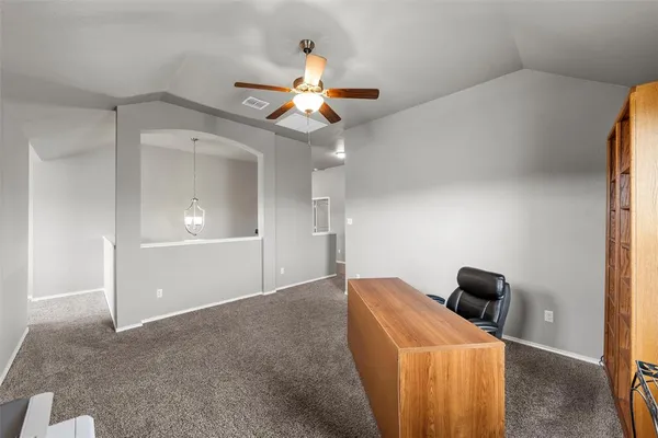 a view of a livingroom with a chandelier fan and a bathroom