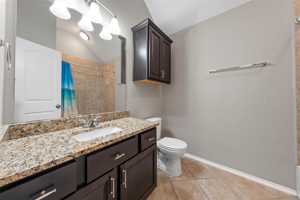 202 Milky Way Road Bruceville, TX 76630 - Photo 29 of 39 a bathroom with a granite countertop sink a toilet and a mirror