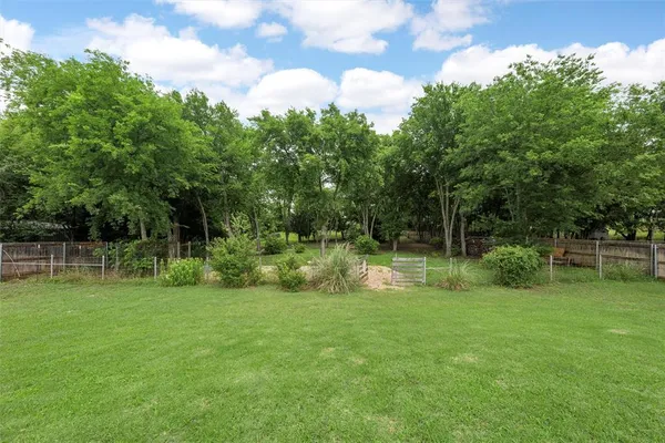a view of green field with sitting area