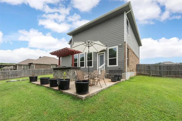 a view of a house with a yard and sitting area