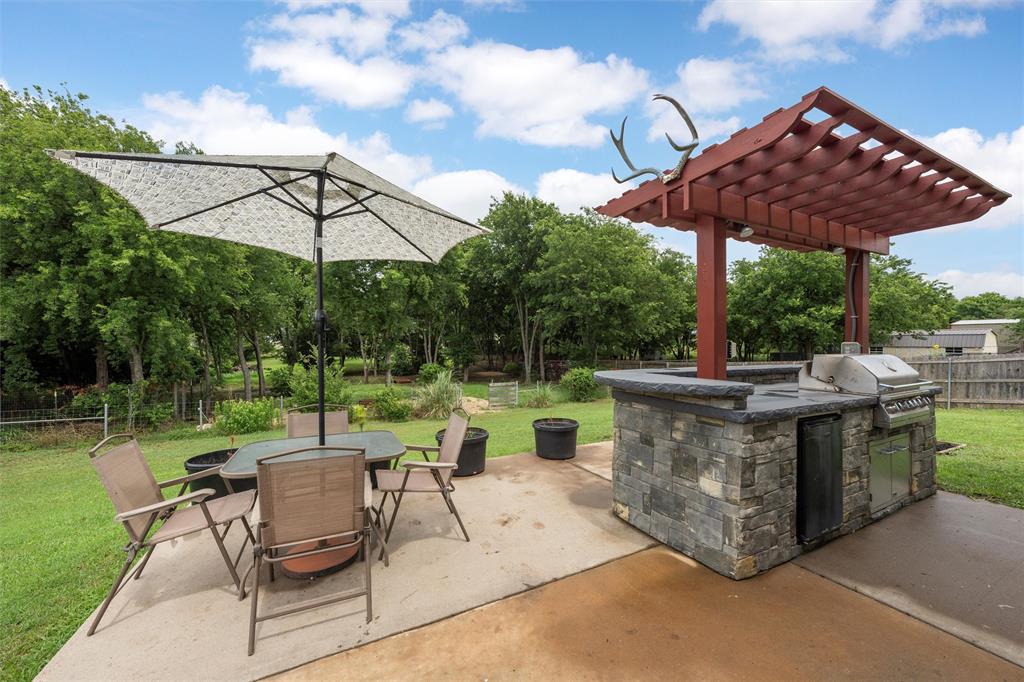 202 Milky Way Road Bruceville, TX 76630 - Photo 34 of 39 a view of a table and chairs under an umbrella in the patio