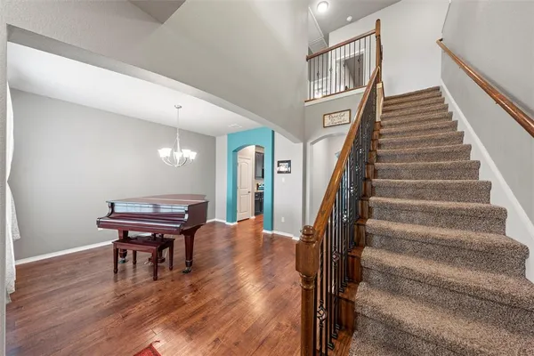 a view of a livingroom with furniture and staircase