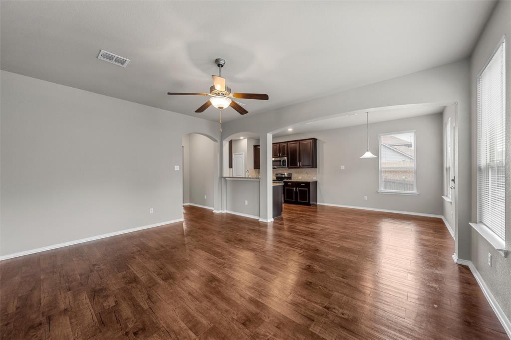 202 Milky Way Road Bruceville, TX 76630 - Photo 7 of 39 a view of empty room with wooden floor and kitchen view