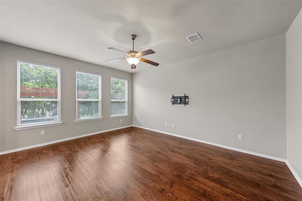 202 Milky Way Road Bruceville, TX 76630 - Photo 8 of 39 a view of an empty room with wooden floor and a window