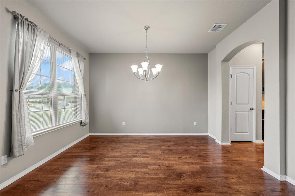 202 Milky Way Road Bruceville, TX 76630 - Photo 10 of 39 a view of a room with window wooden floor and chandelier
