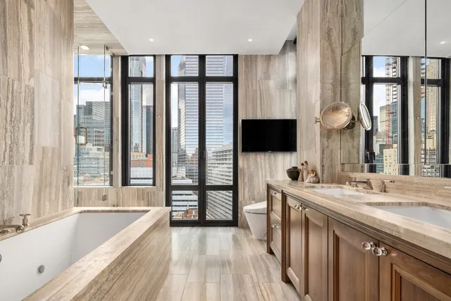 a large bedroom with a large bed and a large window