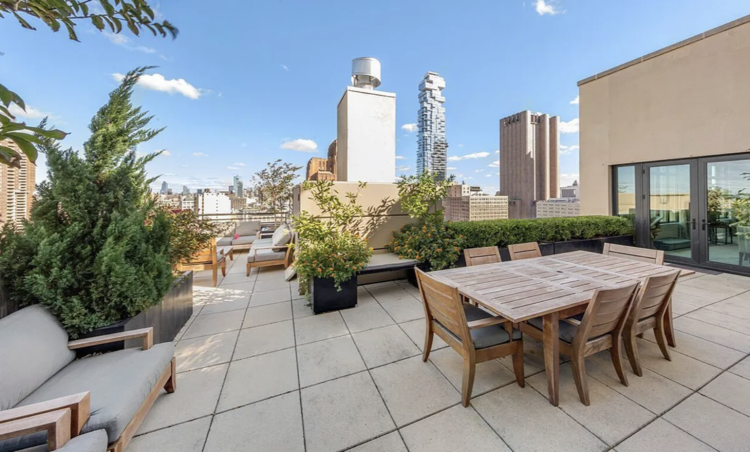 143 Reade Street, Unit PH Manhattan, NY 10013 - Photo 16 of 30 a view of a patio with table and chairs and potted plants