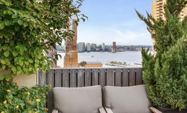 a view of a patio with table and chairs and potted plants