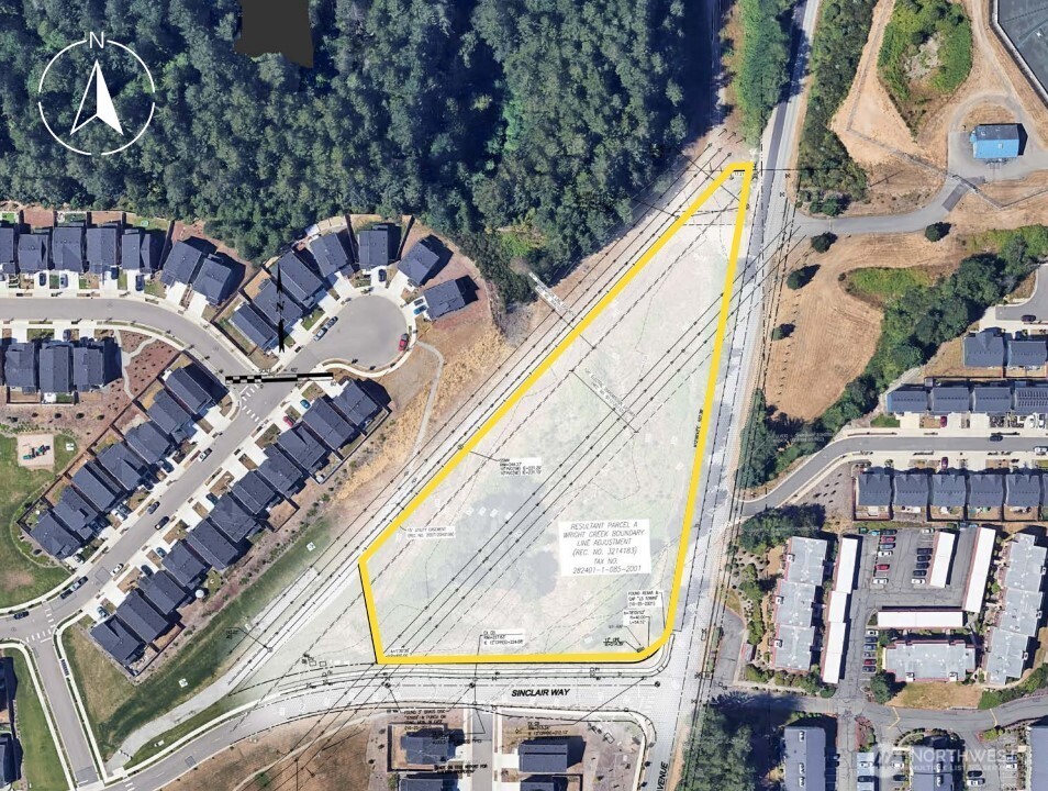 an aerial view of a multi story residential apartment building with a yard