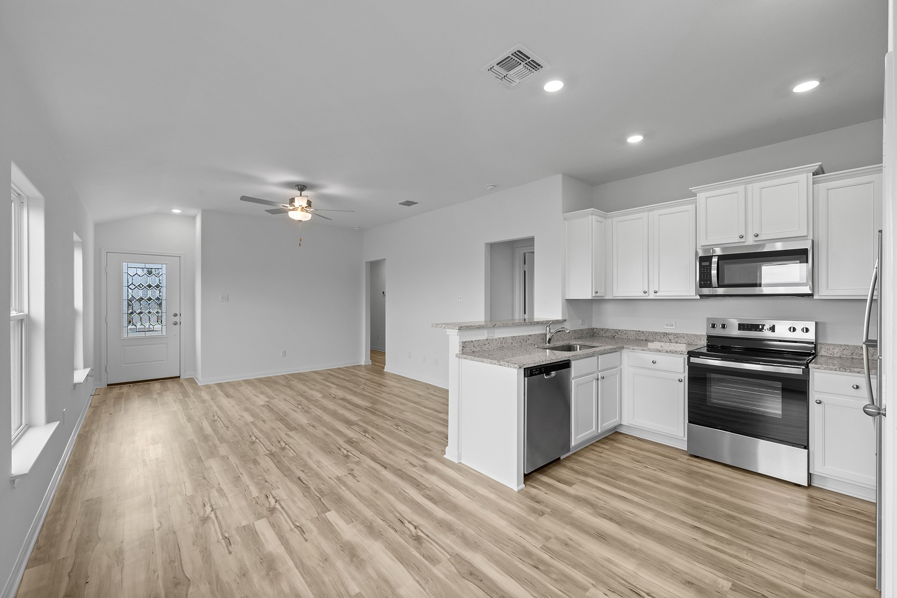 14404 Wahlbergs Way Elgin, TX 78621 - Photo 4 of 10 The kitchen of this plan comes completely chef ready. From the plentiful cabinet space and sprawling granite countertops, to the stainless steel Whirlpool® appliances, this room is sure to make a lasting impression. Additionally, you will love how roomy and open this space is!