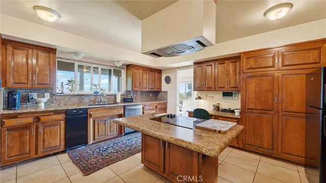 a spacious bedroom with a bed and a dresser next to a window