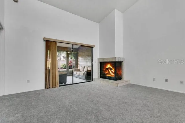 a view of an empty room and fire place