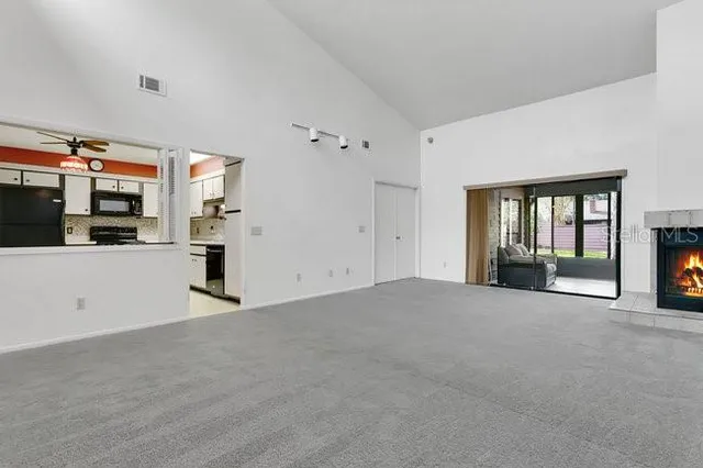 a view of an empty room with a fireplace
