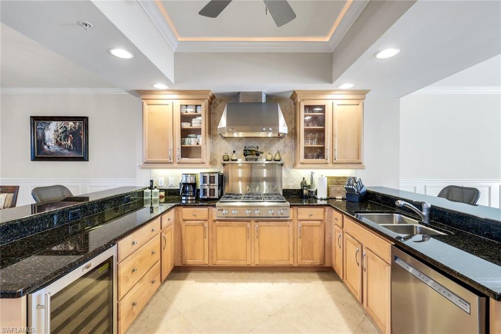 265 Indies Way, Unit T02 Naples, FL 34110 - Photo 12 of 38 a kitchen with granite countertop a sink stove and cabinets