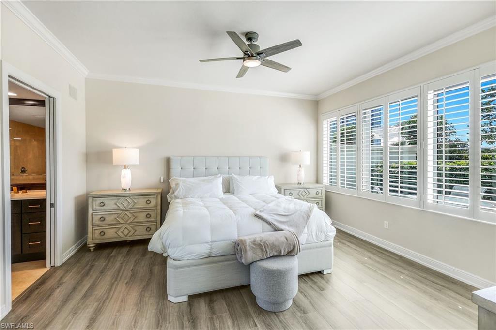 265 Indies Way, Unit T02 Naples, FL 34110 - Photo 16 of 38 a bedroom with a bed and a window