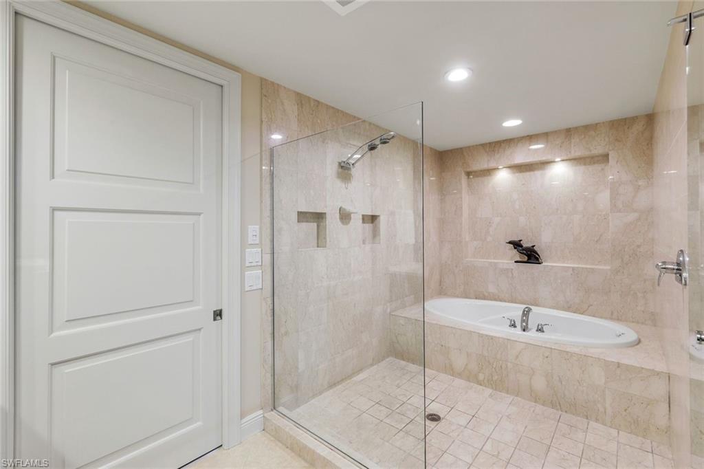 265 Indies Way, Unit T02 Naples, FL 34110 - Photo 20 of 38 a bathroom with a tub and shower