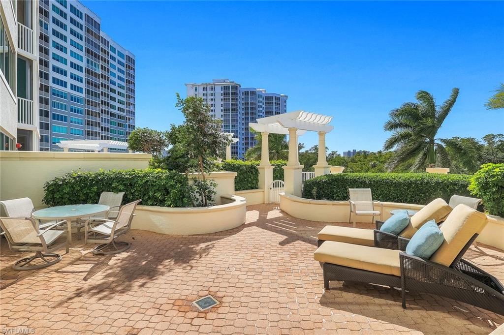 265 Indies Way, Unit T02 Naples, FL 34110 - Photo 28 of 38 a view of a patio with couches and potted plants