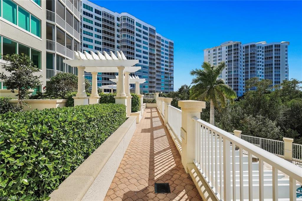 265 Indies Way, Unit T02 Naples, FL 34110 - Photo 30 of 38 a view of a building with a yard