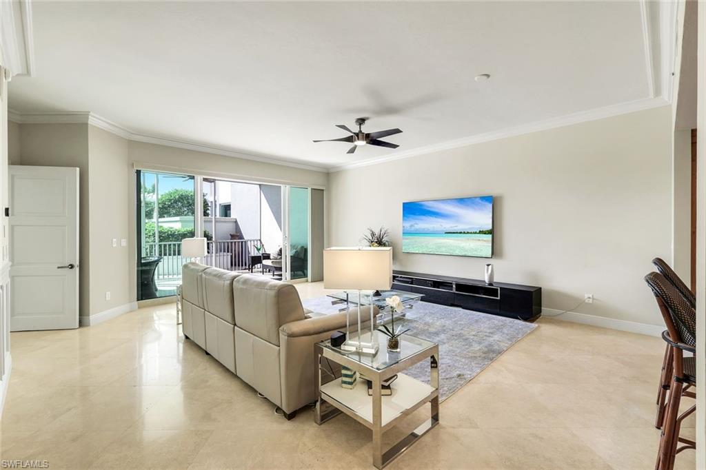 265 Indies Way, Unit T02 Naples, FL 34110 - Photo 4 of 38 a living room with furniture and a flat screen tv