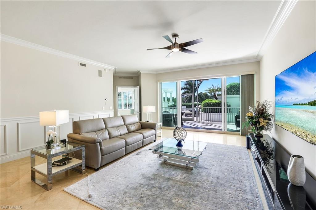 265 Indies Way, Unit T02 Naples, FL 34110 - Photo 6 of 38 a living room with furniture and a flat screen tv