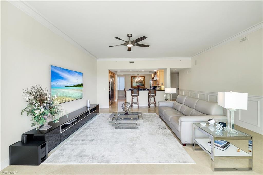 265 Indies Way, Unit T02 Naples, FL 34110 - Photo 7 of 38 a living room with furniture and a flat screen tv