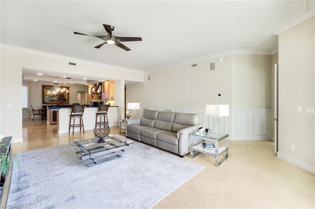 265 Indies Way, Unit T02 Naples, FL 34110 - Photo 8 of 38 a living room with furniture and kitchen view