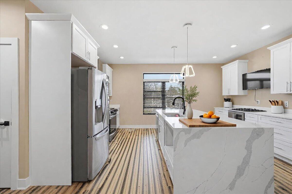 153 Morgan Boulevard, Unit 1 Valparaiso, IN 46383 - Photo 7 of 29 a dining room with stainless steel appliances granite countertop a refrigerator and a sink