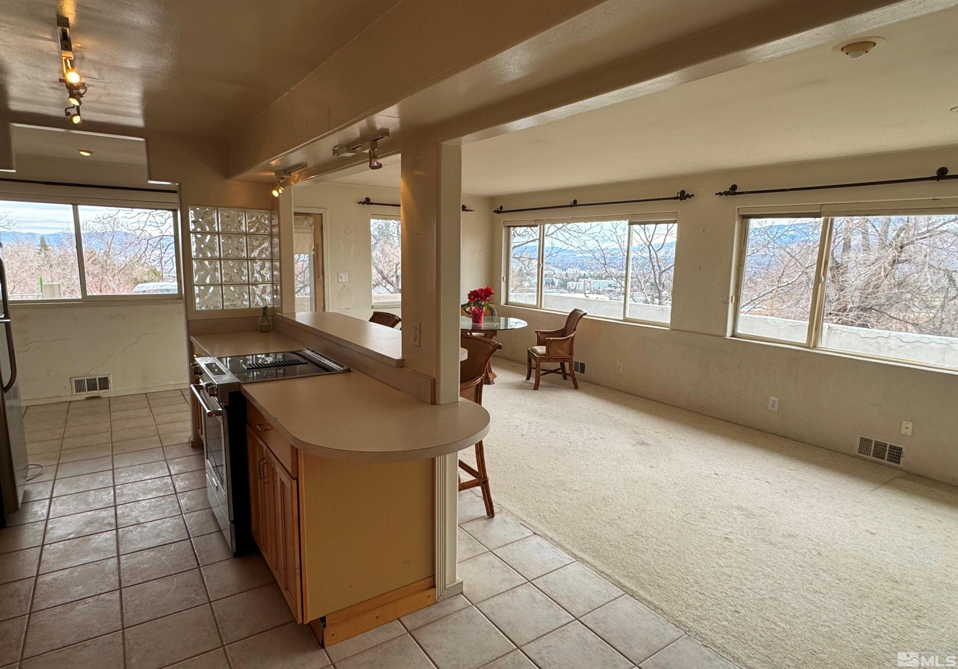 385 Greenstone Drive Reno, NV 89512 - Photo 4 of 34 a kitchen with a sink and large windows