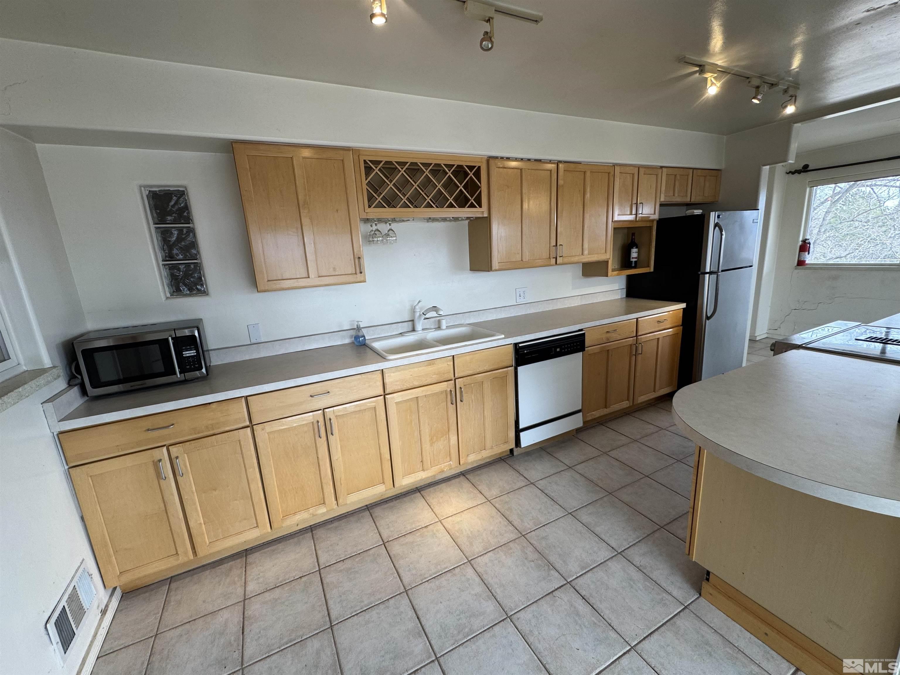 385 Greenstone Drive Reno, NV 89512 - Photo 6 of 34 a kitchen with stainless steel appliances granite countertop a sink and cabinets