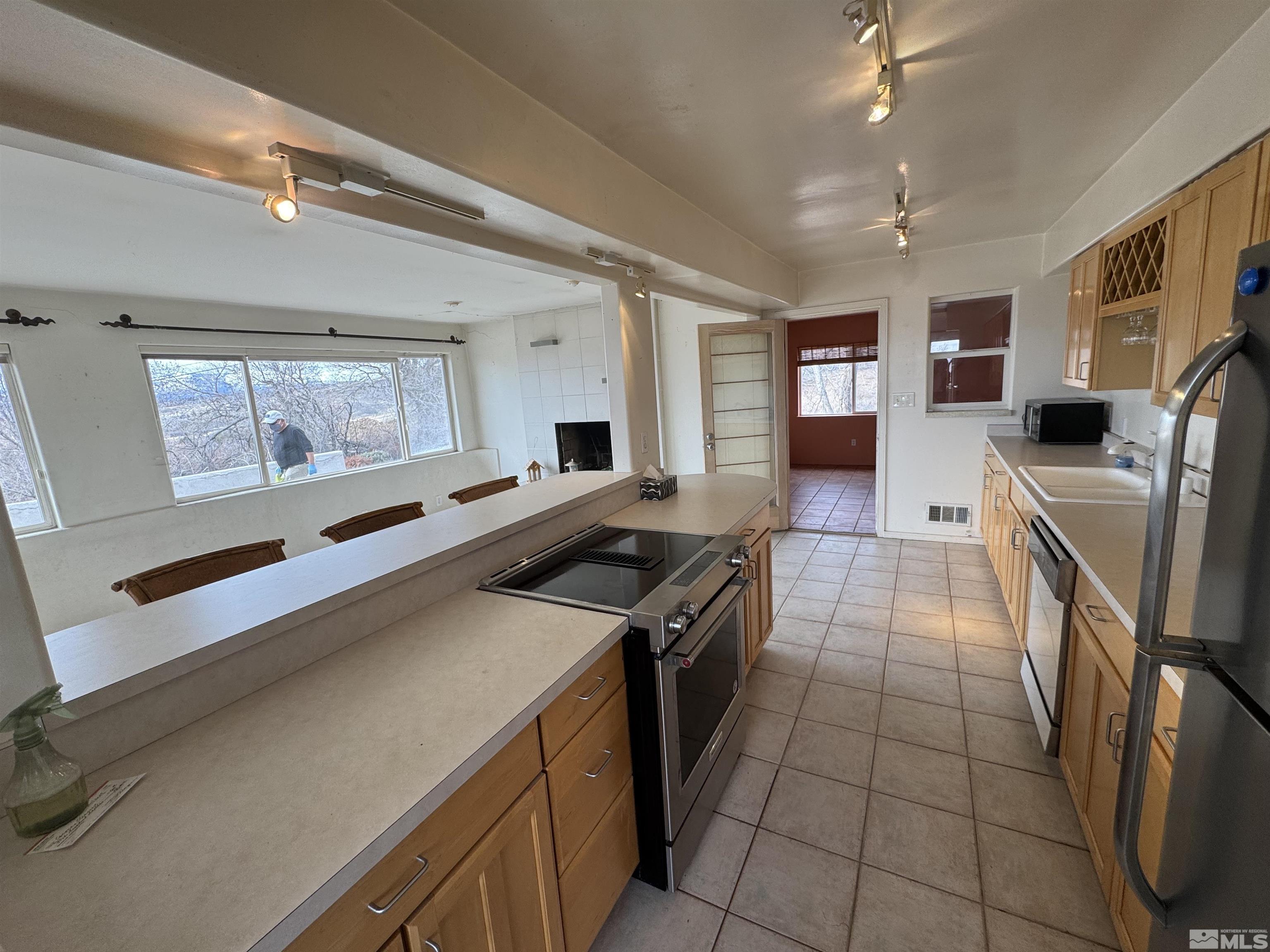 385 Greenstone Drive Reno, NV 89512 - Photo 9 of 34 a kitchen with stainless steel appliances granite countertop a sink stove and refrigerator