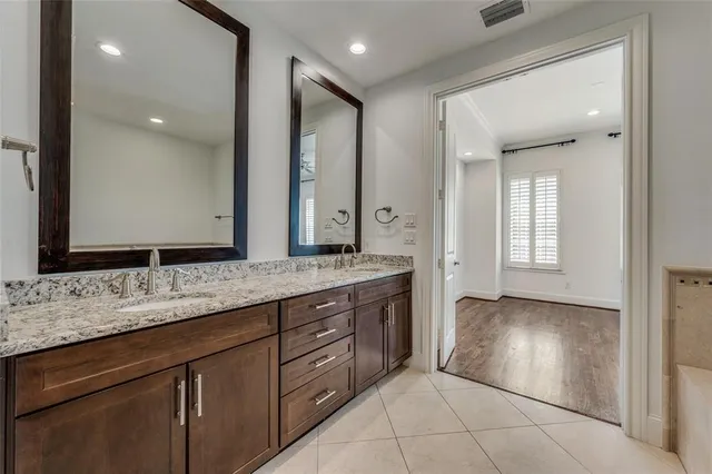 a bathroom with a double vanity sink and a mirror