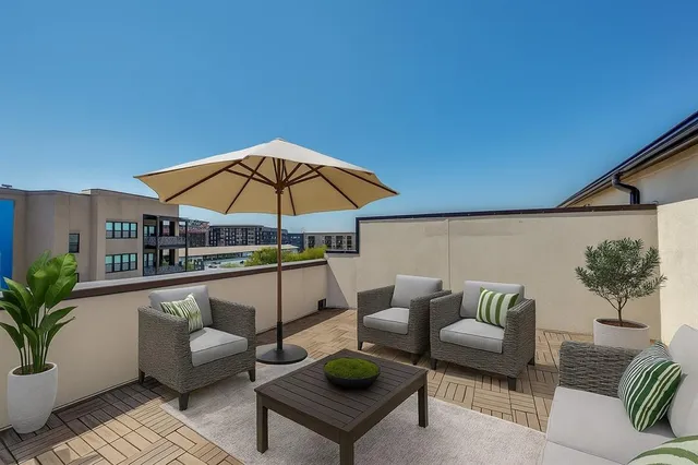 a outdoor living space with furniture and umbrella