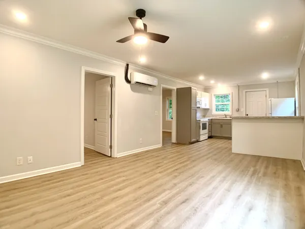 a view of a kitchen with a sink and a refrigerator