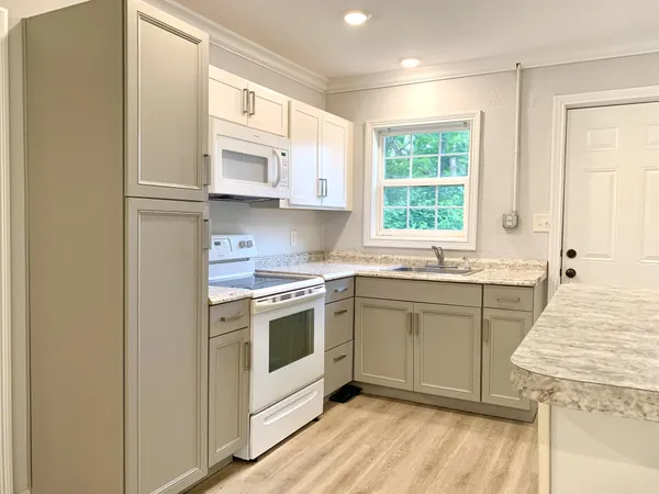 a kitchen with stainless steel appliances granite countertop a stove a sink and a refrigerator