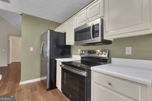 a kitchen with a sink cabinets and window