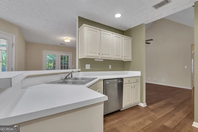 a kitchen with stainless steel appliances a refrigerator and a stove top oven