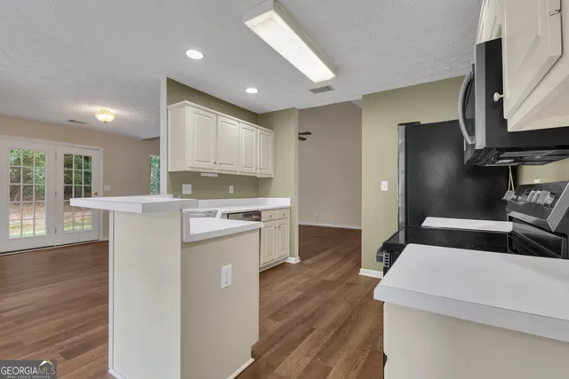 a view of storage and utility room with wooden floor