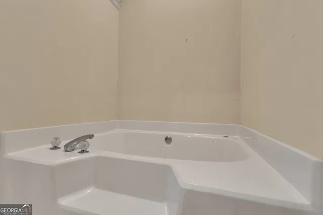 an empty room with a window and a ceiling fan