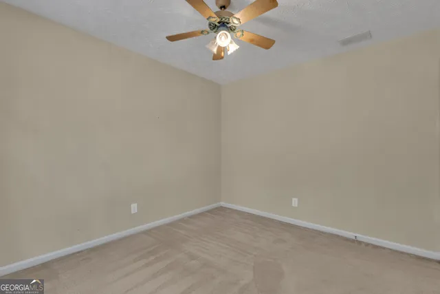 a view of a yard with trees in front of it