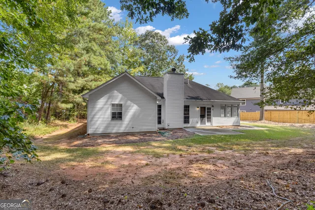 a front view of a house with a yard and a garage